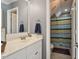 This bathroom features a single sink, tile floors and shower with striped shower curtain at 1300 Marshall Farm St, Wake Forest, NC 27587