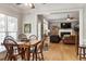 Dining area with natural light and wood table set adjoins living room with fireplace, creating an inviting space at 1300 Marshall Farm St, Wake Forest, NC 27587