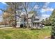 Lovely gray home with a screened porch and mature trees on a well-manicured lawn at 1300 Marshall Farm St, Wake Forest, NC 27587
