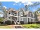Charming two-story home with gray siding, white trim, covered porch and manicured landscaping at 1300 Marshall Farm St, Wake Forest, NC 27587