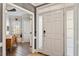 Welcoming foyer with sidelight windows, coat closet and view of an office with wood flooring at 1300 Marshall Farm St, Wake Forest, NC 27587