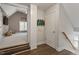 Hallway with stairs, storage closet and decor leads to carpeted room with a TV and ample natural light at 1300 Marshall Farm St, Wake Forest, NC 27587