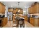 Kitchen with stainless steel appliances, wood cabinets, and a breakfast bar at 1300 Marshall Farm St, Wake Forest, NC 27587