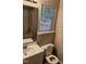 Well-lit bathroom featuring a white vanity, toilet and shower/tub combo with window providing natural light at 132 Waiters Way Way, Youngsville, NC 27596