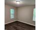 Neutral-toned bedroom with wood-look flooring, natural light, and standard window features at 132 Waiters Way Way, Youngsville, NC 27596