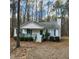Charming one-story home with a front porch and green shutters surrounded by a wooded lot at 132 Waiters Way Way, Youngsville, NC 27596