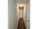 A long hallway features neutral paint, wood-look floors, and white doors at 132 Waiters Way Way, Youngsville, NC 27596