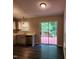 Open kitchen area with stainless steel dishwasher and sliding glass doors to the backyard deck at 132 Waiters Way Way, Youngsville, NC 27596