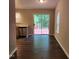 Bright kitchen area leads to an outdoor deck through sliding glass doors, enhancing indoor-outdoor living at 132 Waiters Way Way, Youngsville, NC 27596