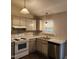 Updated kitchen offering stainless steel appliances, wood-look floors and grey-toned cabinetry at 132 Waiters Way Way, Youngsville, NC 27596