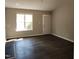 An empty living room is light and bright with wood-look flooring and a window at 132 Waiters Way Way, Youngsville, NC 27596