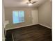 Neutral living room featuring wood-look flooring, a ceiling fan, and a white entry door at 132 Waiters Way Way, Youngsville, NC 27596