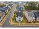 Aerial view of a neighborhood showcasing the home's manicured lawn, landscaping, and charming front porch at 1332 Gloriosa St, Apex, NC 27523