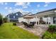 Expansive backyard with a patio featuring outdoor seating, a built-in grill, and a charming fireplace at 1332 Gloriosa St, Apex, NC 27523