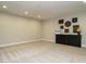 Basement area with neutral walls, carpeting, recessed lighting, and a display cabinet at 136 Glenpark Pl, Cary, NC 27511