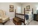 Traditional-style bedroom featuring a four-poster bed, vintage trunk, and patterned armchair at 136 Glenpark Pl, Cary, NC 27511