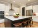 Modern kitchen with white cabinets, stainless steel appliances, and a large center island at 136 Glenpark Pl, Cary, NC 27511