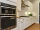 Gourmet kitchen featuring stainless steel appliances, white cabinets, and ample counter space at 136 Glenpark Pl, Cary, NC 27511