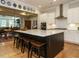 Open concept kitchen with a center island, bar seating and view into the dining and living rooms at 136 Glenpark Pl, Cary, NC 27511