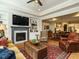 Inviting living room featuring a fireplace, built-in shelves and a view of the dining area at 136 Glenpark Pl, Cary, NC 27511