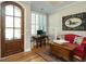 View of a home office area adjacent to the foyer with a wooden door and hardwood floors at 136 Glenpark Pl, Cary, NC 27511