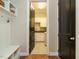Mud room featuring bench seating, coat hooks, and a view into the laundry room at 136 Glenpark Pl, Cary, NC 27511