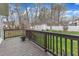 A wooden deck overlooks a spacious yard with a storage shed and a white picket fence, perfect for outdoor enjoyment at 1410 Briardale Ln, Durham, NC 27712