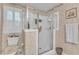 White bathroom with tile shower and an open window for fresh air to enter at 1410 Briardale Ln, Durham, NC 27712