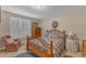 A quiet bedroom provides comfortable carpet, light walls, and bright, shuttered windows at 1410 Briardale Ln, Durham, NC 27712