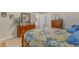 This quaint primary bedroom features a decorative wooden bed frame, soft lighting, and wooden dressers at 1410 Briardale Ln, Durham, NC 27712