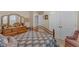 Comfortable bedroom with a beautiful bedspread, wooden furniture and view into the en suite bathroom at 1410 Briardale Ln, Durham, NC 27712