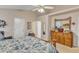 Large bedroom with vaulted ceiling, wooden furniture and view into the hallway at 1410 Briardale Ln, Durham, NC 27712