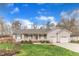 Charming single-story home featuring a well-manicured lawn, inviting front porch, and attached two-car garage at 1410 Briardale Ln, Durham, NC 27712