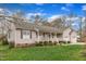 Charming home with a welcoming front porch, well-manicured lawn, and beautiful landscaping at 1410 Briardale Ln, Durham, NC 27712