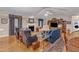 Spacious living room showcasing hardwood floors, a fireplace, and comfortable seating arrangements at 1410 Briardale Ln, Durham, NC 27712