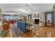 Open-concept living area with hardwood floors, fireplace, and vaulted ceiling at 1410 Briardale Ln, Durham, NC 27712
