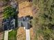 An aerial view displays a lovely home with a gray roof, surrounded by lush trees and a well-maintained lawn at 1429 Sagamore Dr, Louisburg, NC 27549