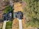 An aerial view displays a lovely home with a gray roof, surrounded by lush trees and a well-maintained lawn at 1429 Sagamore Dr, Louisburg, NC 27549