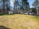 The large backyard has grass, various trees, and multiple outbuildings including a shed at 1429 Sagamore Dr, Louisburg, NC 27549