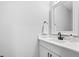 Modern bathroom features a white vanity with black hardware and a framed mirror at 1429 Sagamore Dr, Louisburg, NC 27549