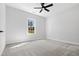 Bedroom features carpet flooring, a window, and a ceiling fan at 1429 Sagamore Dr, Louisburg, NC 27549