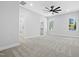 Bright primary bedroom with carpet, ceiling fan, and ensuite bath at 1429 Sagamore Dr, Louisburg, NC 27549