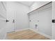 A well-lit closet space with a rod for hanging clothes and washer/dryer hookups at 1429 Sagamore Dr, Louisburg, NC 27549