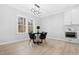 Dining room with modern lighting and a view of the backyard through large windows at 1429 Sagamore Dr, Louisburg, NC 27549