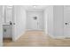 Bright entryway with light wood floors, a front door with glass panes, and a view of the adjacent bathroom at 1429 Sagamore Dr, Louisburg, NC 27549