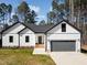 Charming new construction home featuring white siding, a gray roof, and an attached two-car garage at 1429 Sagamore Dr, Louisburg, NC 27549