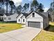 Beautiful home with a long driveway, lush green grass, and mature trees at 1429 Sagamore Dr, Louisburg, NC 27549