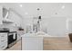 A kitchen featuring an island with a sink, white cabinets, and stainless appliances at 1429 Sagamore Dr, Louisburg, NC 27549