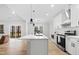 A kitchen with an island, stainless steel appliances, and a view into the adjacent living room at 1429 Sagamore Dr, Louisburg, NC 27549