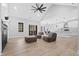 Bright living room with a ceiling fan, fireplace, and sliding doors leading to the outside deck at 1429 Sagamore Dr, Louisburg, NC 27549